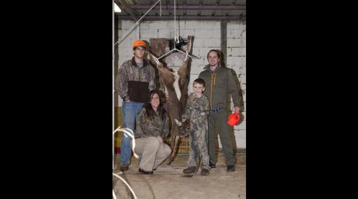 A successful youth hunter, his guide and his family.