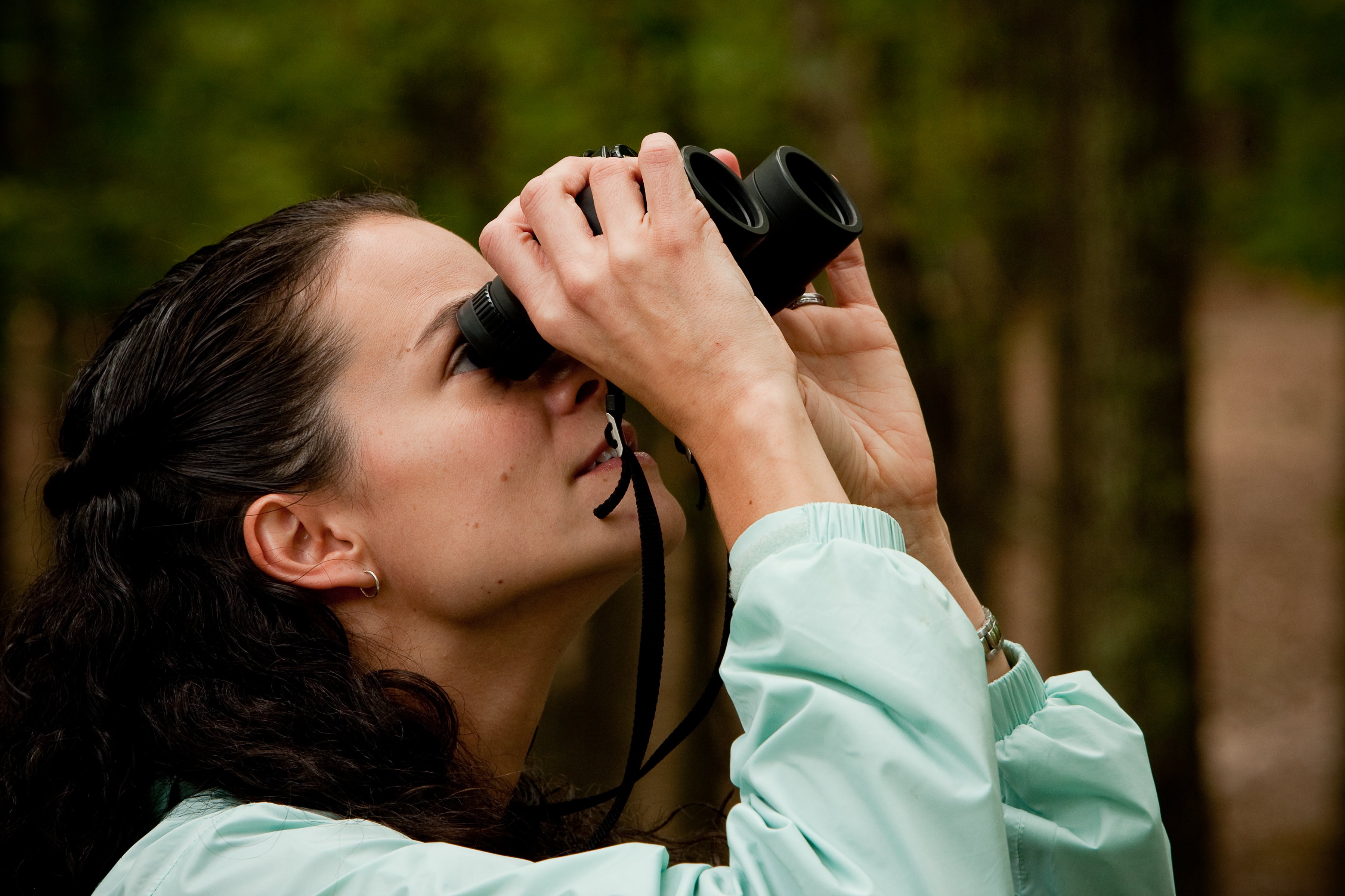 woman looking through binoculars